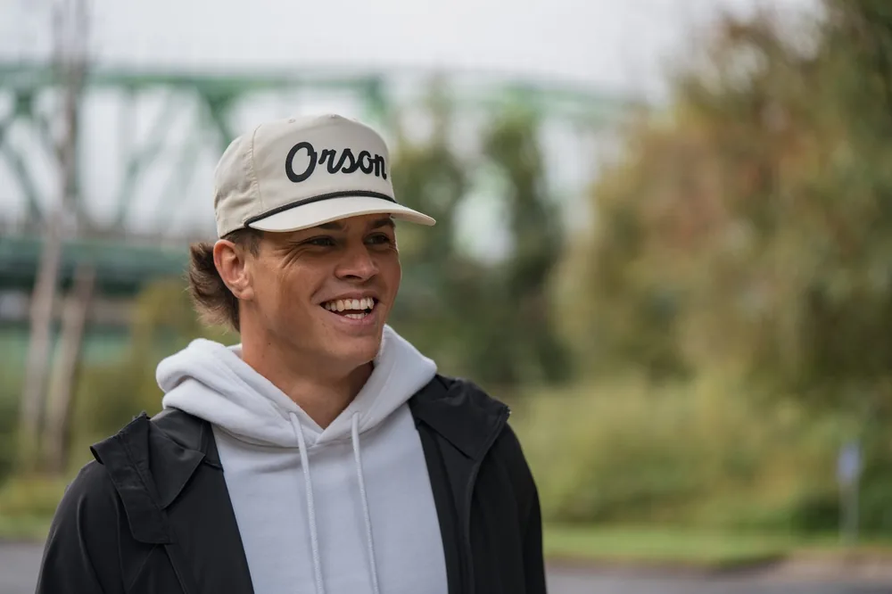 Man wearing a custom embroidered cap outdoors