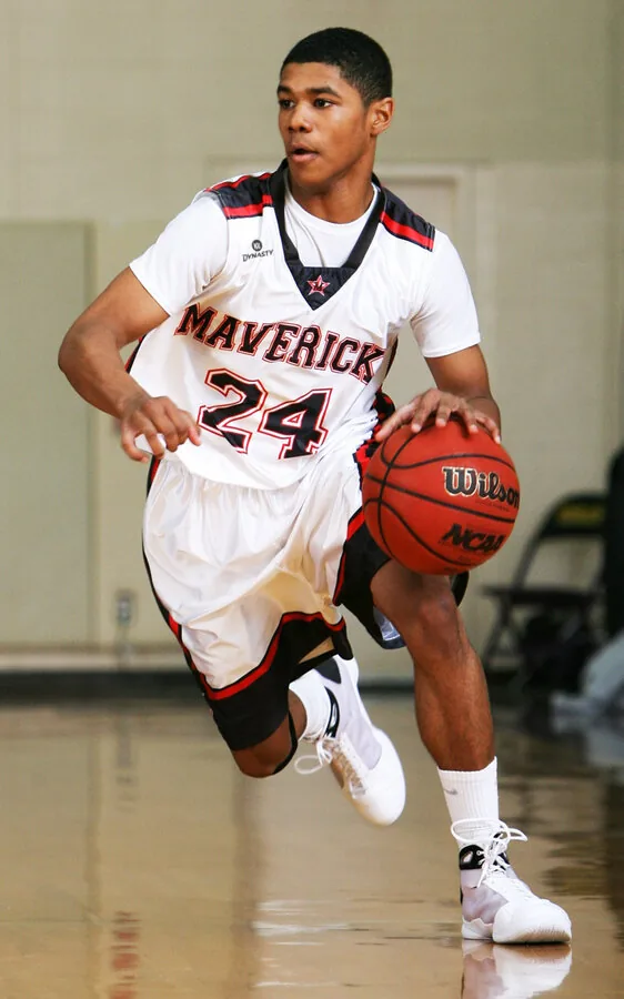 Basketball player in custom Maverick jersey driving to the basket