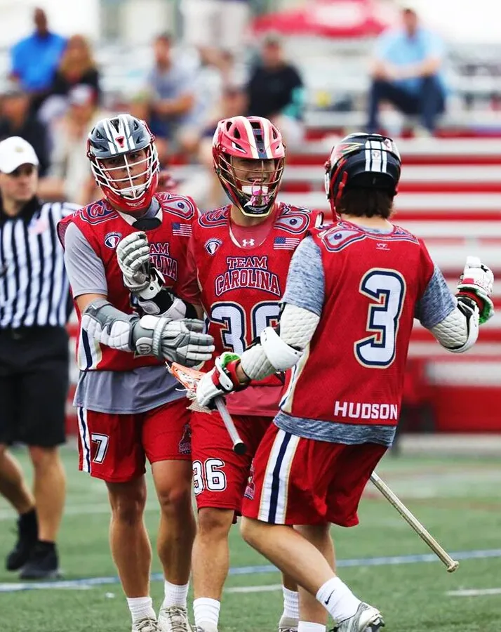 Lacrosse team in custom red and grey sublimated jerseys