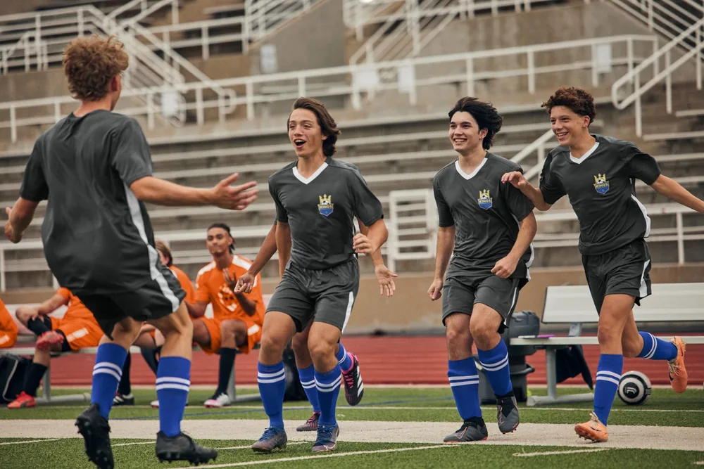 Youth soccer team in custom grey and blue uniforms