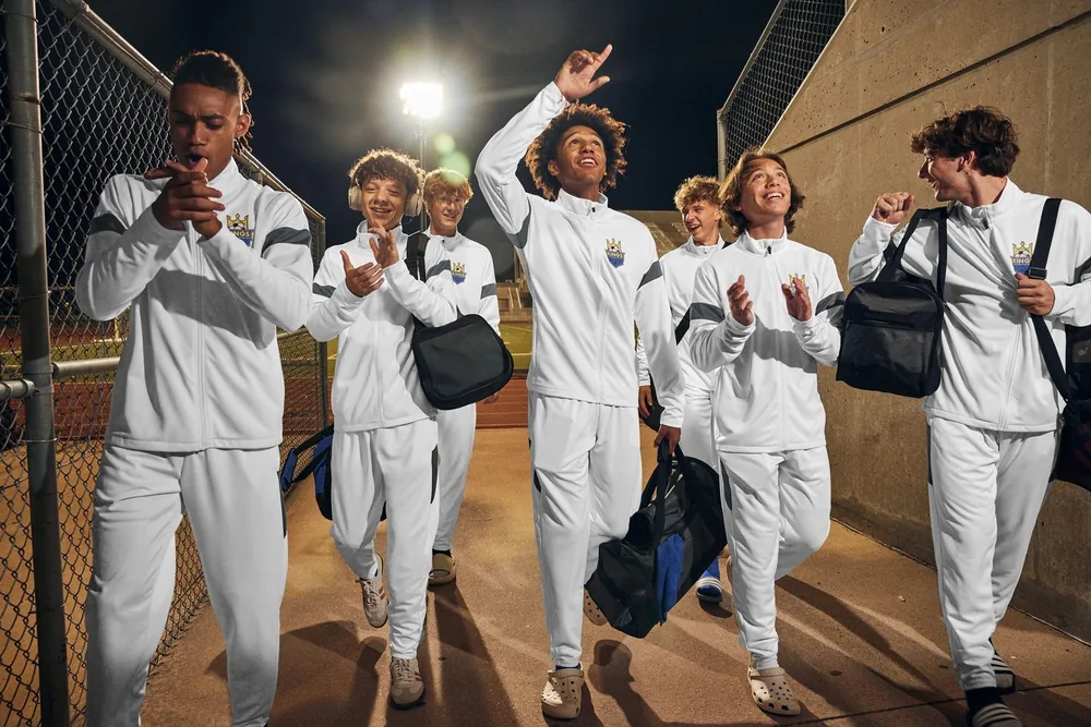Team in custom white warm-up tracksuits
